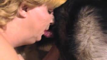 Blonde woman wearing black stockings penetrated by a dog