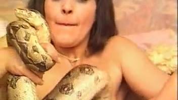 Hot chicks playing around with an even hotter serpent