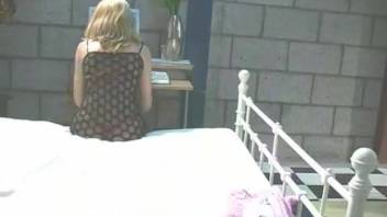 A white dog receives a handjob from a blonde woman with firm breasts