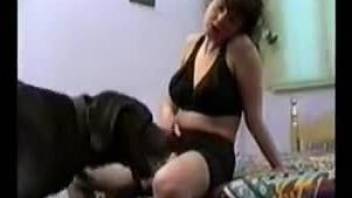 Dark-haired hottie getting licked and dicked by a dog