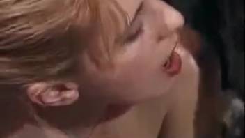 Blonde beauty deepthroats a canine's crimson dick