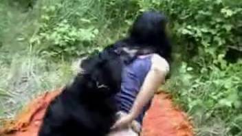 Dark-haired woman cheerfully screwing a canine outdoors