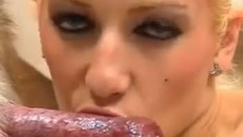 Attractive blond woman performs messy oral sex on a dog's penis in various sloppy ways