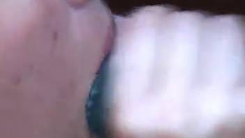 Fair-haired woman blowing a massive horse dick outside