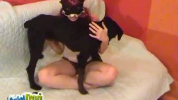 Disguised girl passionately kisses her ebony canine, fantastic